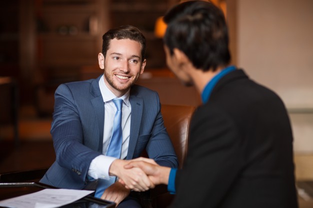 two-happy-partners-shaking-hands-cafe_1262-3667